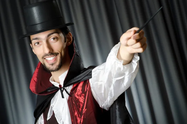 Magician doing tricks on white — Stock Photo, Image