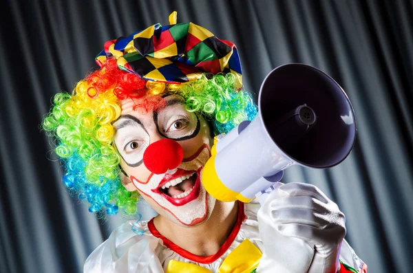 Clown in studio with loudspeaker — Stock Photo, Image