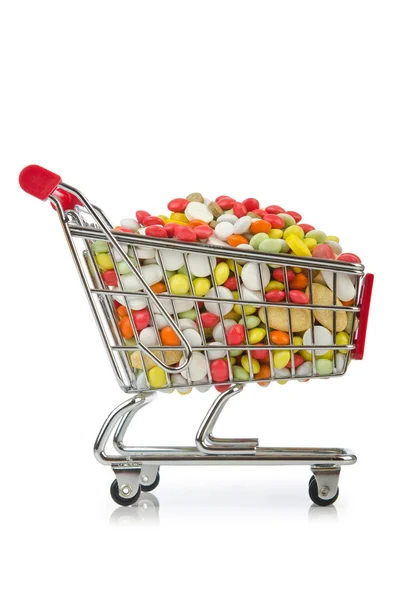 Carrito de compras con muchas píldoras de colores —  Fotos de Stock