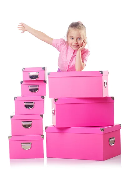 Niña linda con un montón de cajas — Foto de Stock