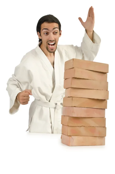 Karate man breaking bricks on white — Stok Foto