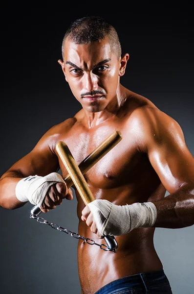 Hombre fuerte con nunchaku —  Fotos de Stock