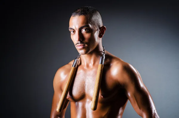 Hombre fuerte con nunchaku —  Fotos de Stock