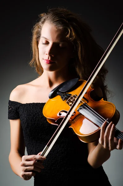 暗い部屋でバイオリンを持つ女性 — ストック写真