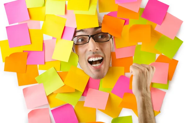 Man's face through paper and reminders — Stock Photo, Image