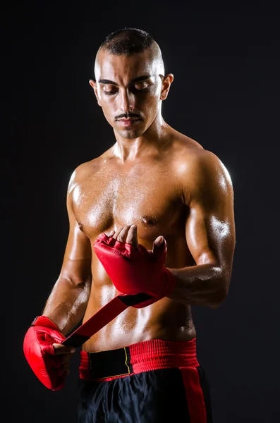 Boxer with red gloves in dark room — Stock Photo, Image