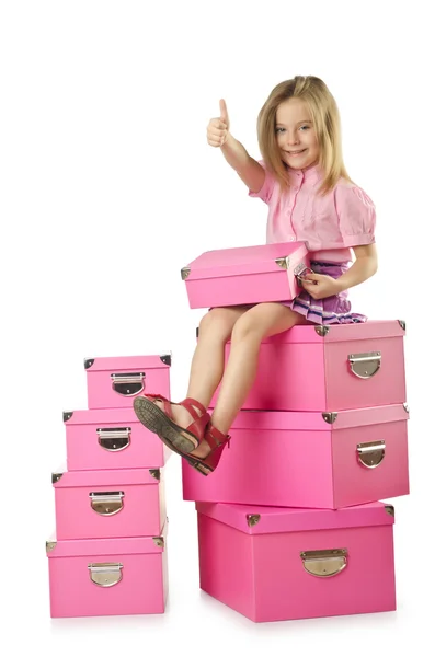 Niña linda con un montón de cajas — Foto de Stock