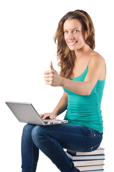 Student with netbook sitting on books — Stock Photo, Image