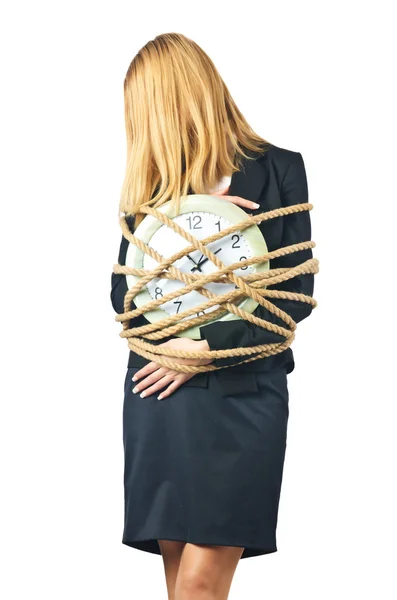 Businesswoman with clock tied up on white — Stock Photo, Image