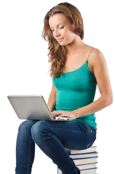 Student with netbook sitting on books — Stock Photo, Image