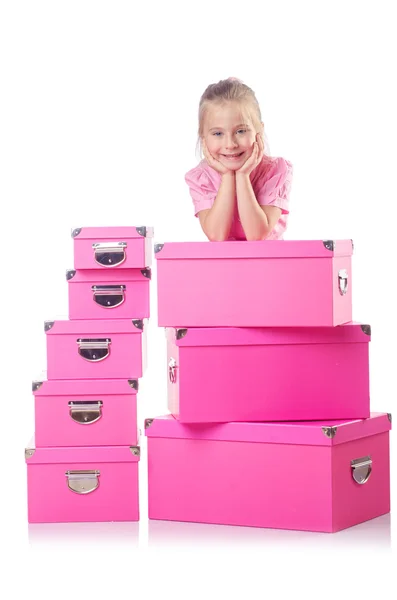 Niña linda con un montón de cajas — Foto de Stock