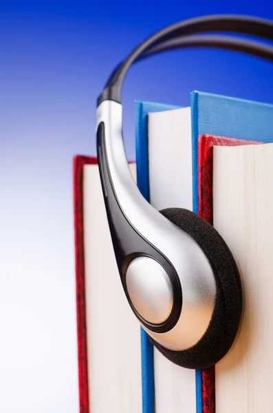 Concept of audio books with earphones on white — Stock Photo, Image