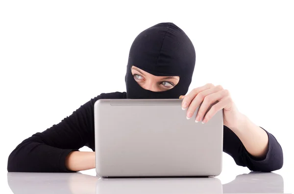 Hacker with computer wearing balaclava — Stock Photo, Image