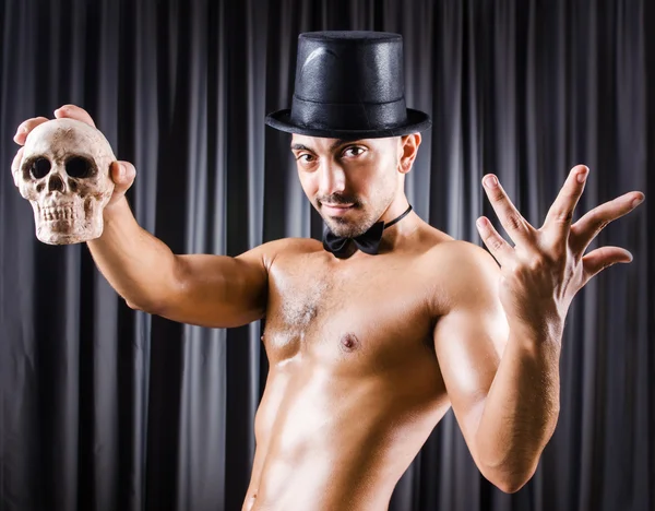 Muscular actor with mask against curtain — Stock Photo, Image