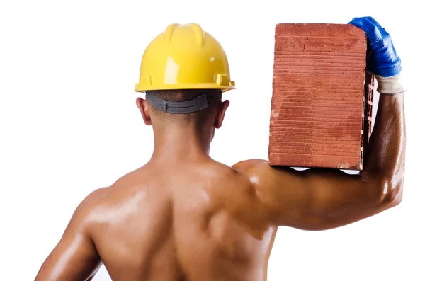 Muscular builder with bricks on white — Stock Photo, Image