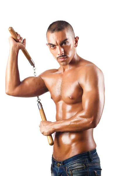 Homem no conceito de artes marciais com nunchucks — Fotografia de Stock