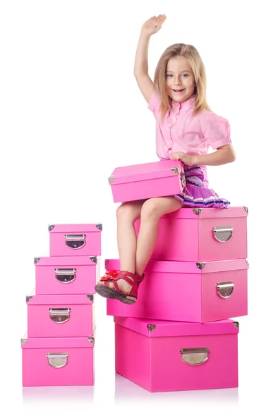 Niña linda con un montón de cajas — Foto de Stock