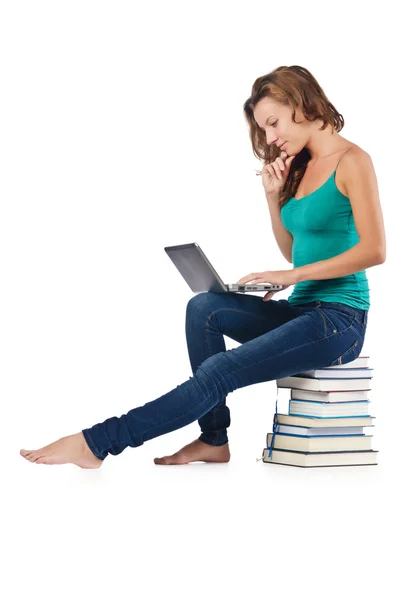 Student with netbook sitting on books — Stock Photo, Image