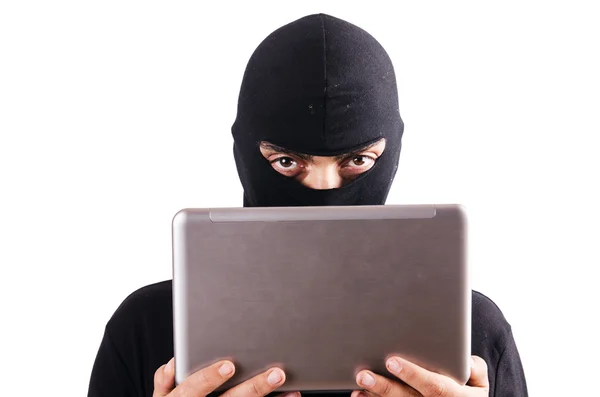 Hacker with computer wearing balaclava — Stock Photo, Image