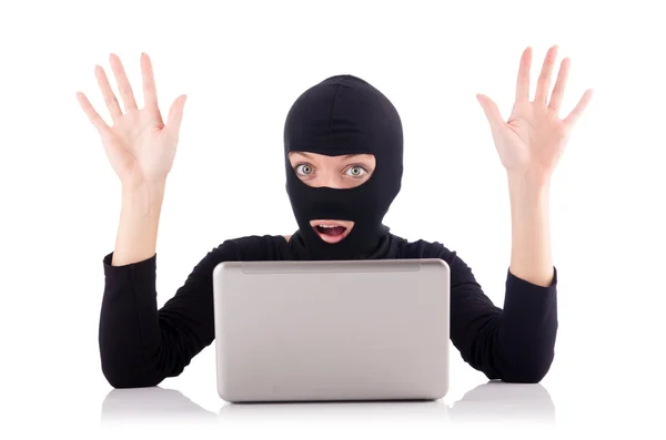 Hacker with computer wearing balaclava — Stock Photo, Image