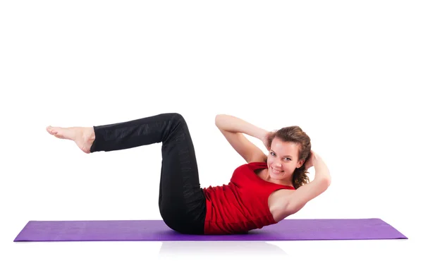 Jeune femme faisant des exercices sur blanc — Photo