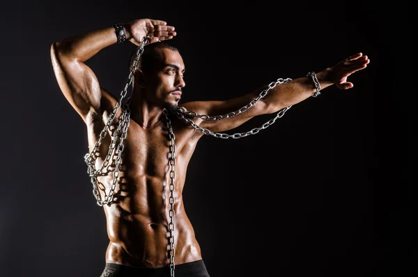 Uomo muscolare con catena su sfondo nero — Foto Stock