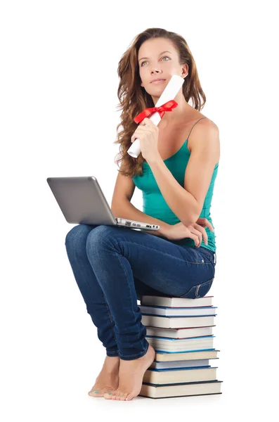 Student z netbook siedzi na książkach — Zdjęcie stockowe