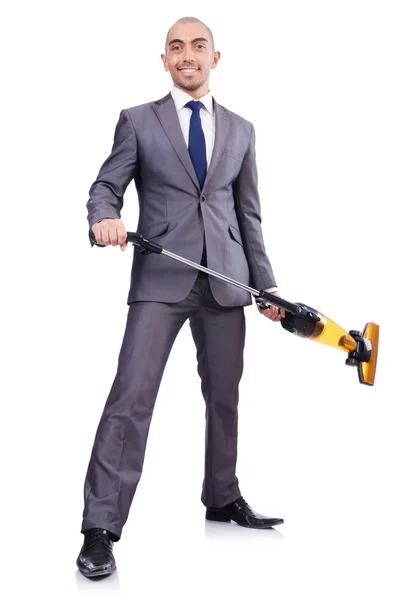 Businessman doing vacuum cleaning on white — Stock Photo, Image