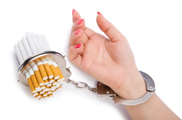 Addition concept with cigarettes and handcuffs — Stock Photo, Image