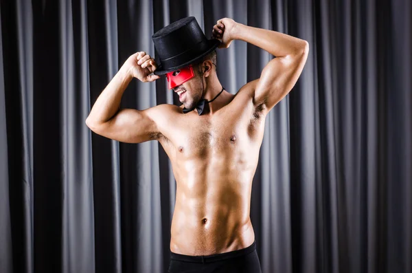 Muscular actor with mask against curtain — Stock Photo, Image