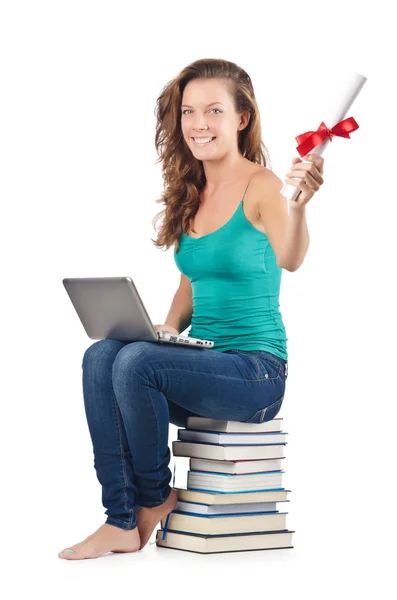 Estudante com netbook sentado em livros — Fotografia de Stock