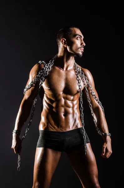 Muscular man with chain on black background — Stock Photo, Image