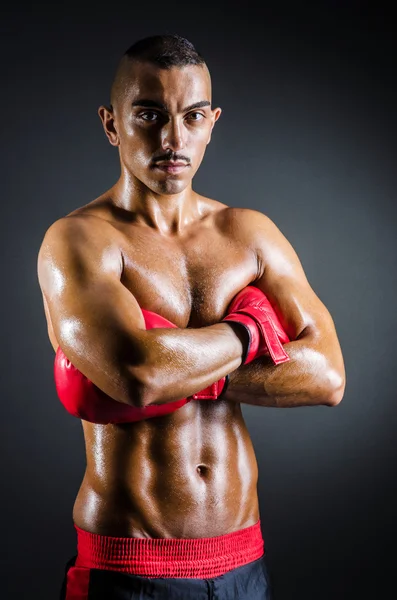 Boxer with red gloves in dark room — Stock Photo, Image