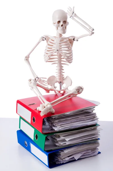 Skeleton with pile of files on white — Stock Photo, Image