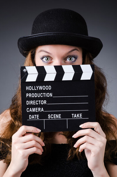 Woman with movie clapper board