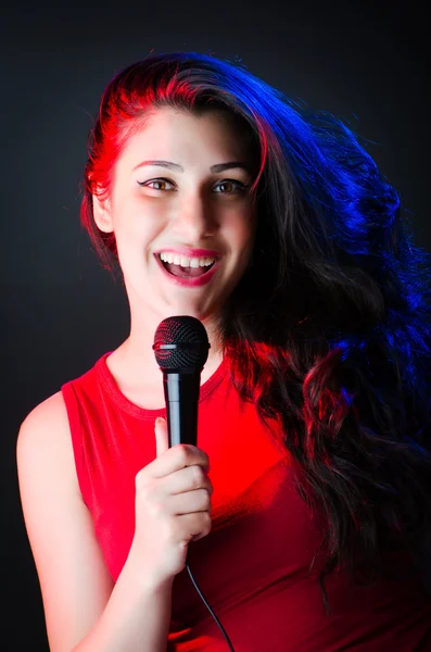 Female performer at disco with mic — Stock Photo, Image