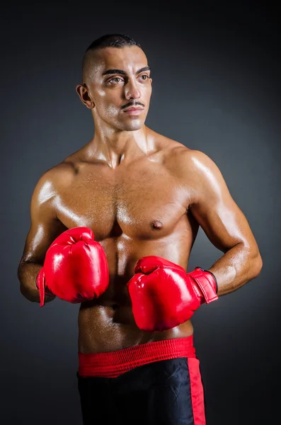 Boxer avec gants rouges dans la chambre noire — Photo