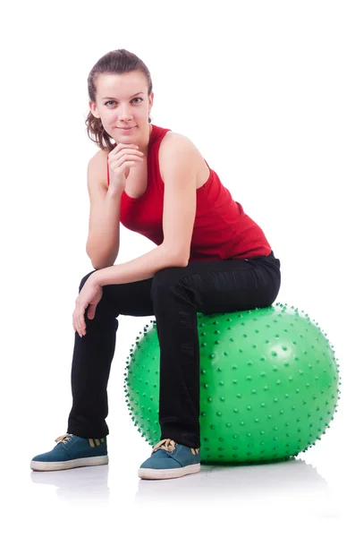 Mujer joven con pelota haciendo ejercicio sobre blanco —  Fotos de Stock