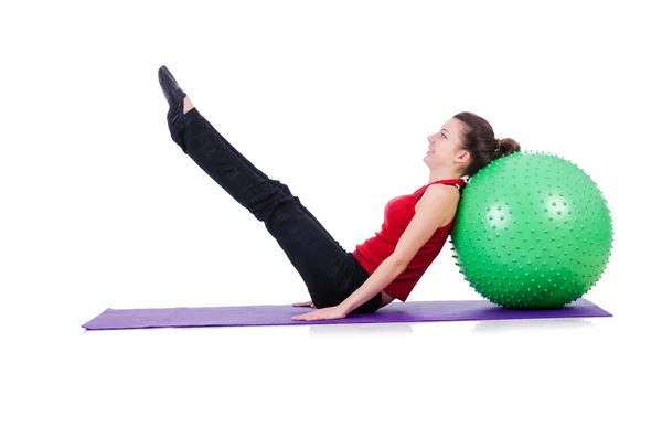 Young woman with ball exercising on white — Stock Photo, Image