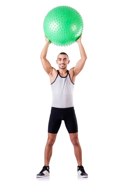 Homem com bola suíça fazendo exercícios em branco — Fotografia de Stock