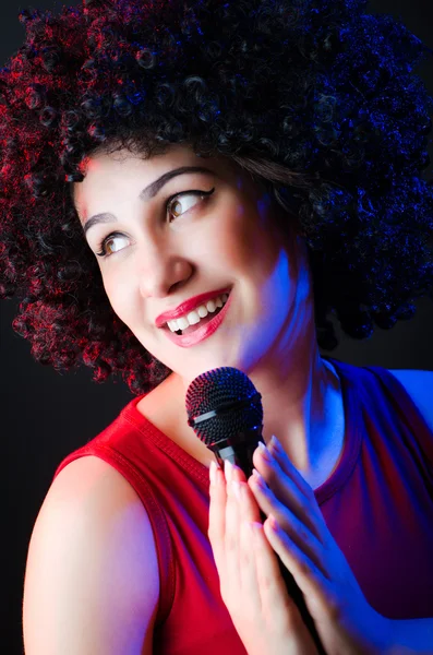 Female performer at disco with mic — Stock Photo, Image