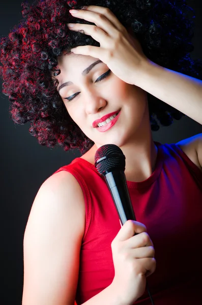 Female performer at disco with mic — Stock Photo, Image