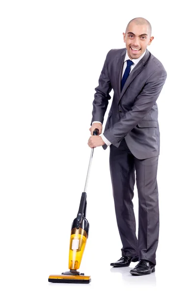 Businessman doing vacuum cleaning on white — Stock Photo, Image