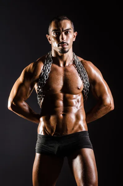 Muscular man with chain on black background — Stock Photo, Image