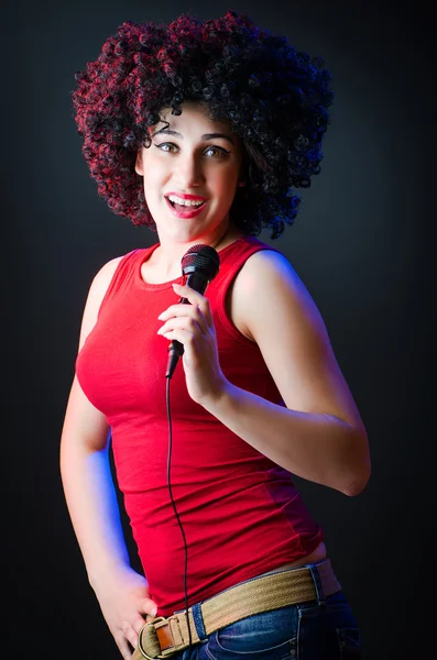 Female performer at disco with mic — Stock Photo, Image