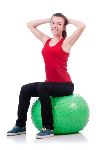 Young woman with ball exercising on white — Stock Photo, Image