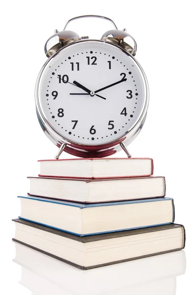 Alarm clock and books isolated on white — Stock Photo, Image