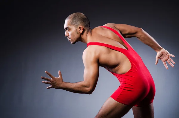 Young wrestler in dark studio — Stock Photo, Image