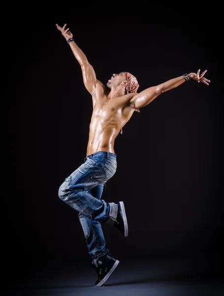 Dancer dancing in the dark studio — Stock Photo, Image