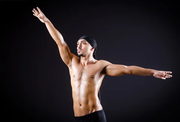 Dancer dancing in the dark studio — Stock Photo, Image